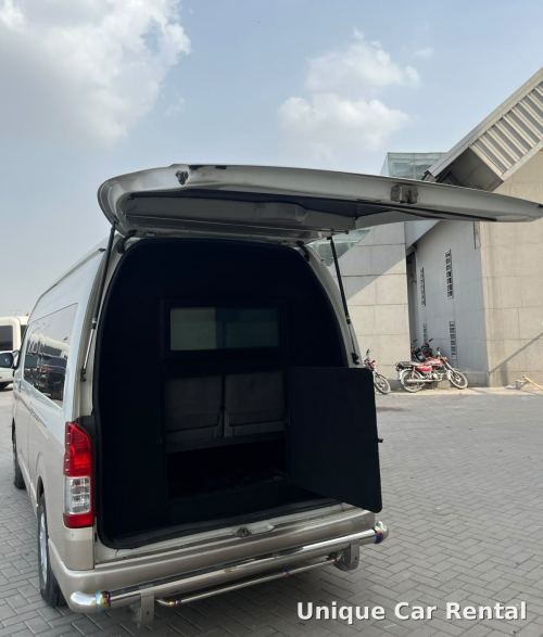 Armored Toyota Hiace van with rear door open showing the protected compartment