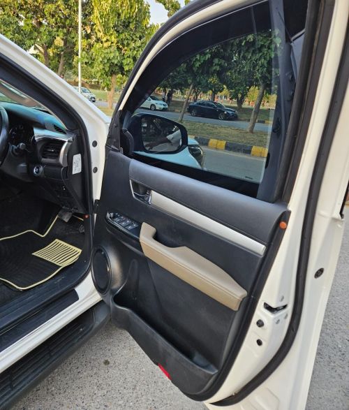 Bulletproof Toyota Hilux Revo for rent in Lahore - front door interior
