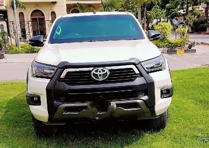 Bulletproof Toyota Hilux Revo for rent in Lahore - white front grille