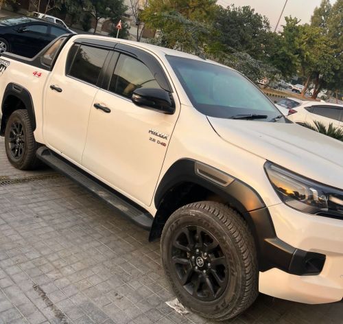 Bulletproof Toyota Hilux Revo for rent in Lahore - white front side