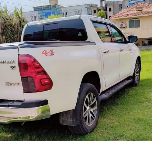 Bulletproof Toyota Hilux Revo for rent in Lahore - white rear side