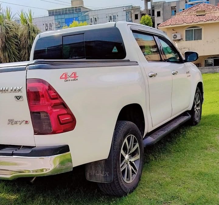 Bulletproof Toyota Hilux Revo for rent in Lahore - white rear side