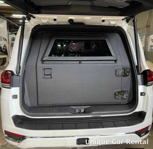White armored Toyota Land Cruiser 300 with rear compartment and ballistic window