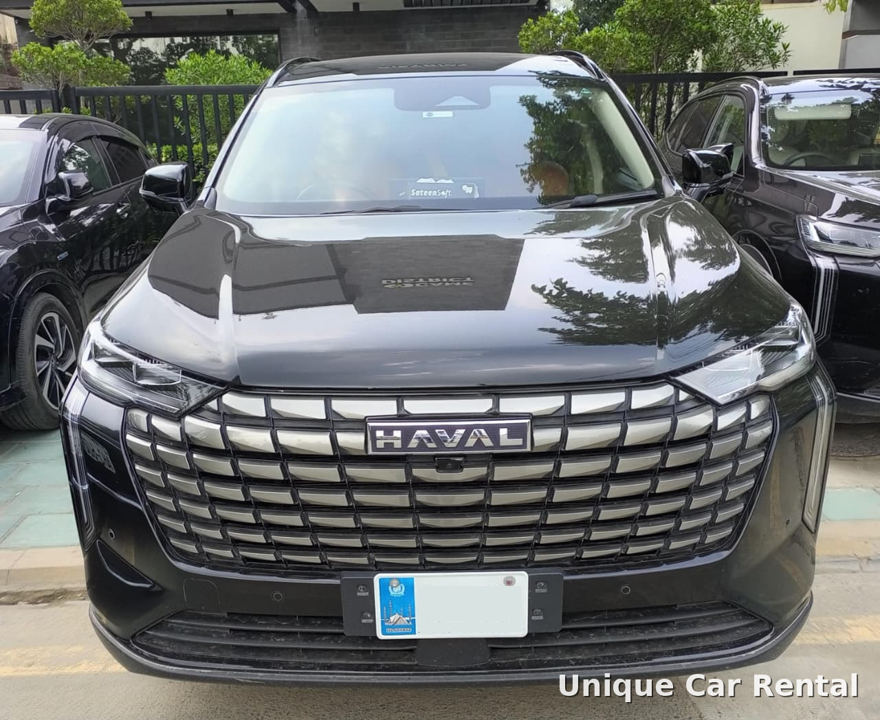 Black Haval SUV front view with large chrome grille