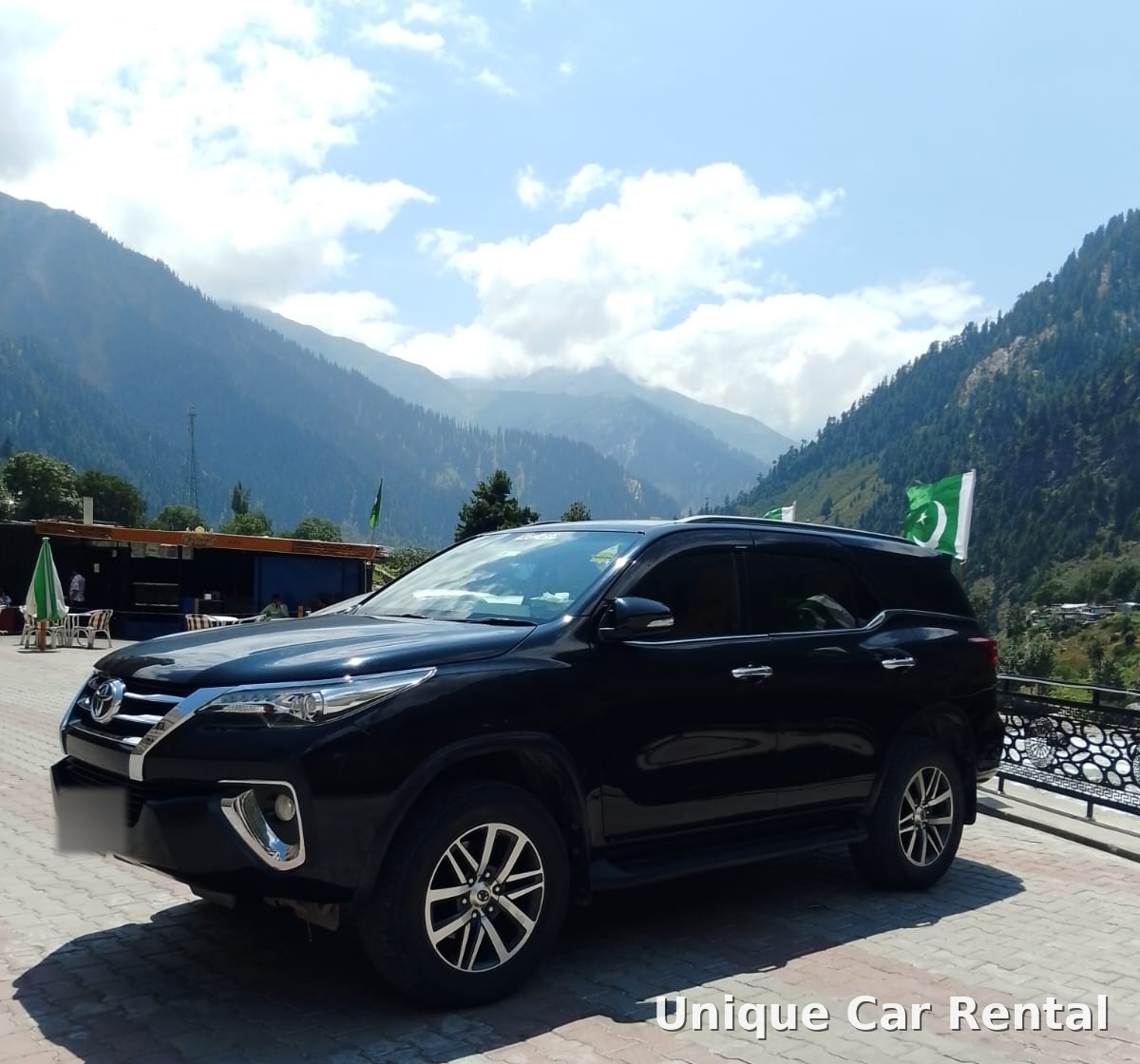 Black Toyota Fortuner parked in a mountain valley in northern Pakistan