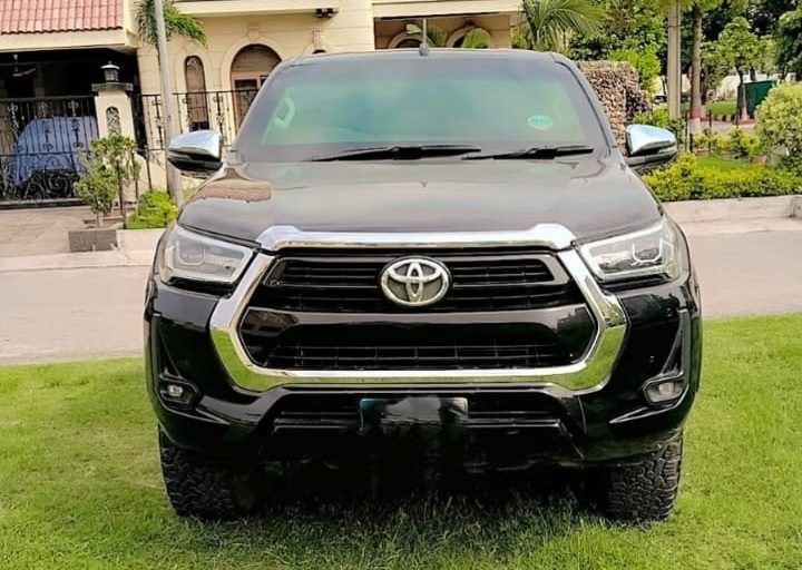 Toyota Hilux Revo for rent in Lahore - black front lawn
