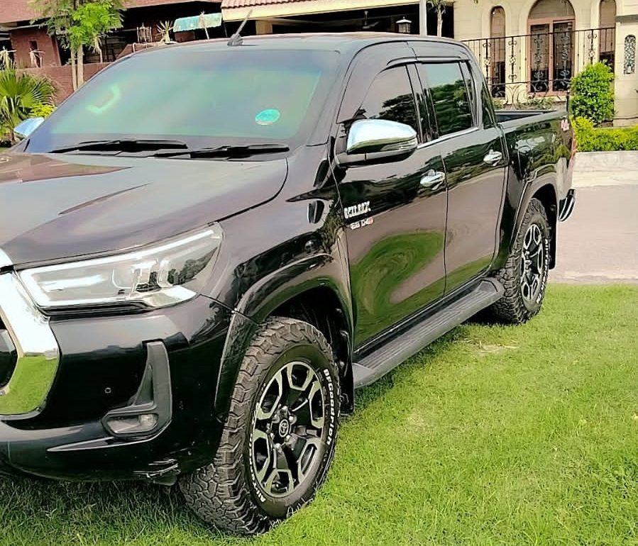 Toyota Hilux Revo for rent in Lahore - black front side