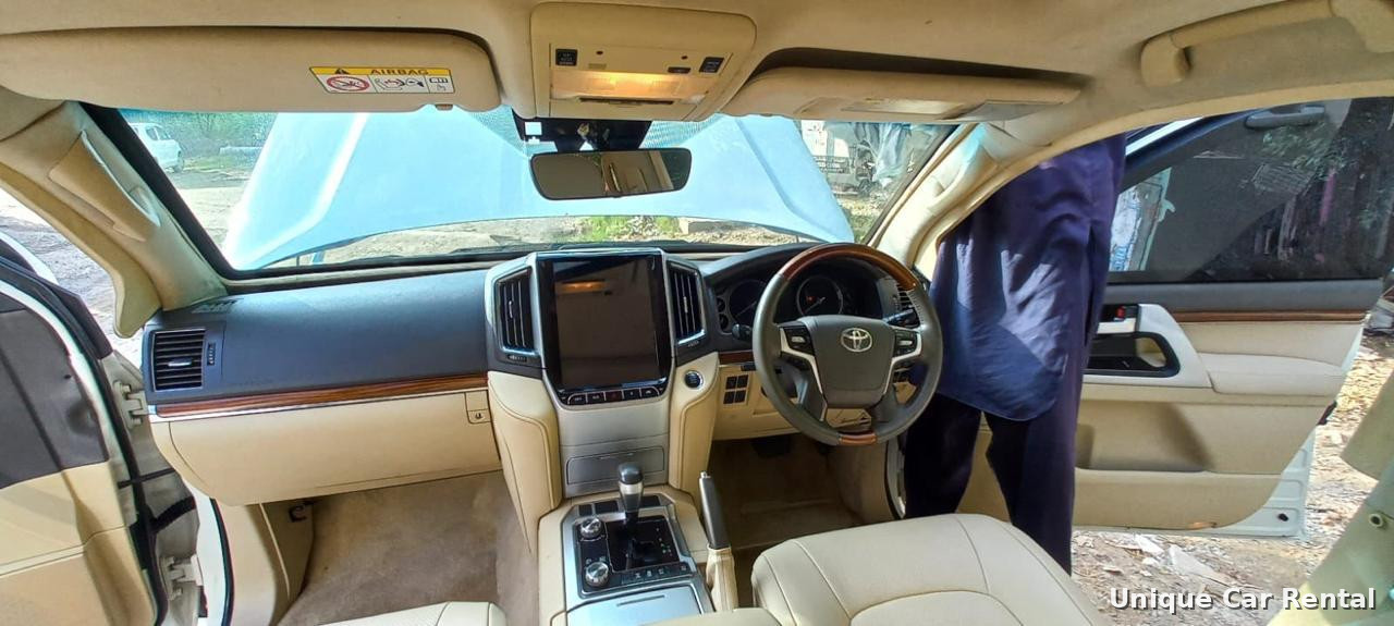 Toyota Land Cruiser 200 interior with cream leather seats and large touchscreen
