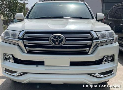 White Toyota Land Cruiser 200 front grille and headlights close-up