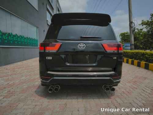Black Toyota Land Cruiser 300 ZX rear view with quad exhaust