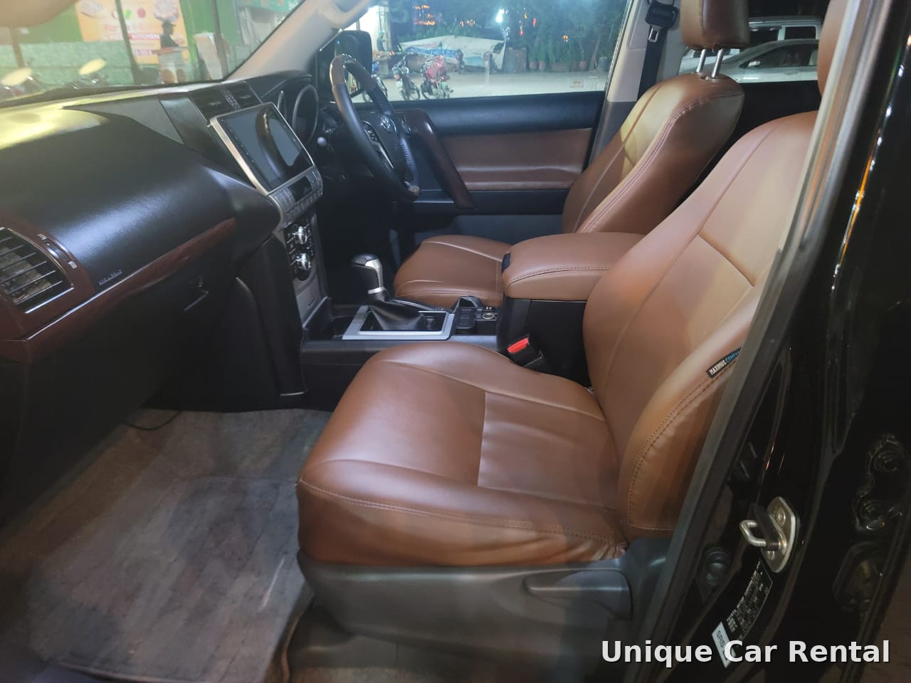 Front seats in brown leather inside a Toyota Land Cruiser Prado