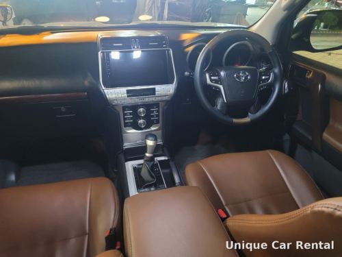 Toyota Land Cruiser Prado dashboard, steering wheel and brown leather seats