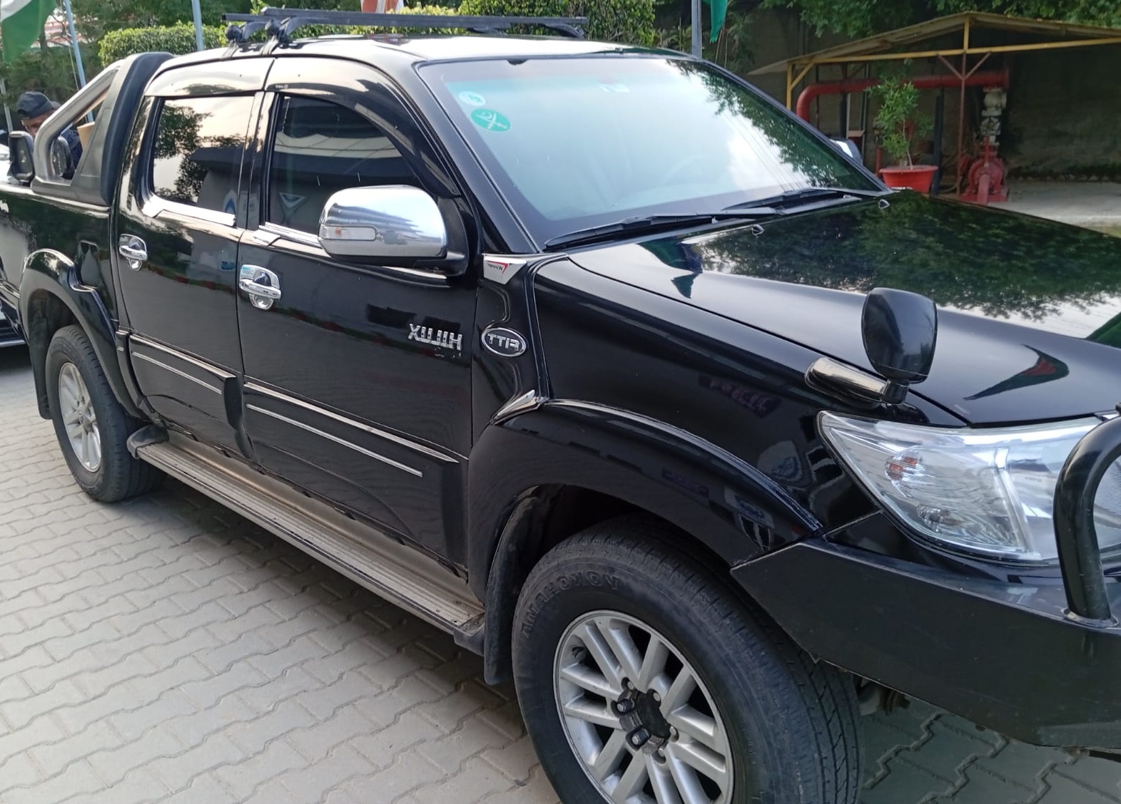 chauffeur driving armored Land Cruiser V8 in Lahore