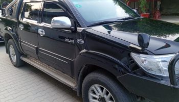 chauffeur driving armored Land Cruiser V8 in Lahore