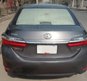 Toyota Corolla rear view on Lahore road during drive