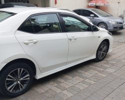 Toyota Corolla Altis 1.8 White available for rent with driver in Lahore